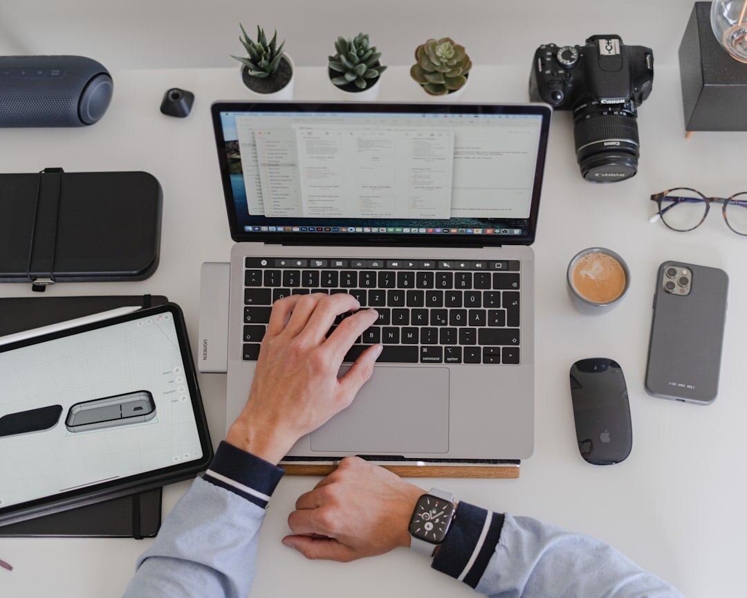 Person reviewing a portfolio of work at a desk with camera equipment nearby
